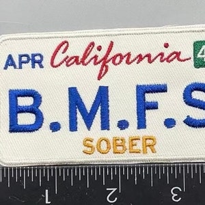 May include: A white patch with blue, red, and yellow embroidery. The patch reads "APR California 420 B.M.F.S. SOBER".