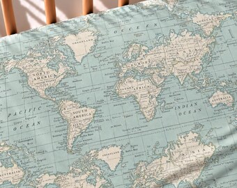 May include: A light blue fabric sheet featuring a repeating vintage-style world map print in cream and dark grey. The map displays continents, oceans, and geographical labels such as North America, South America, Europe, Africa, and Asia.