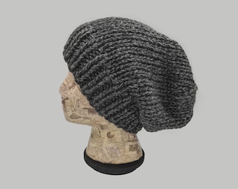 May include: A slouchy beanie hat in a dark gray color with a textured knit pattern.