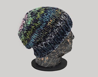 May include: A colorful knit beanie hat with a slouchy fit. The hat is made with a variety of colors, including blue, green, pink, and white.
