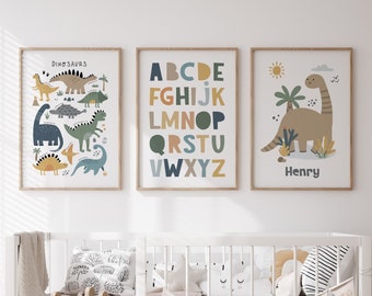 May include: Three framed prints with a nursery theme. The left print features colorful dinosaurs with the word "Dinosaurs" at the top. The middle print features the alphabet in colorful letters. The right print features a brown dinosaur with the name "Henry" at the bottom.
