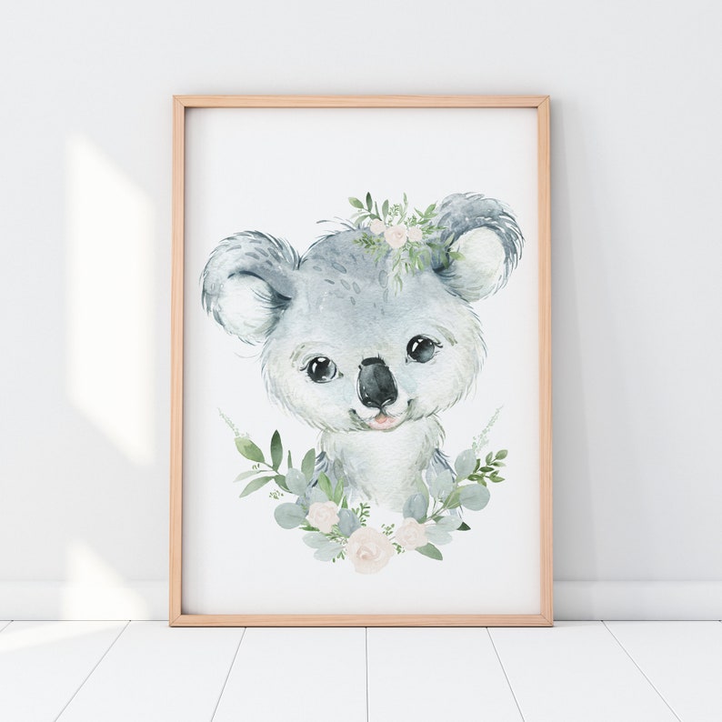 May include: A watercolour painting of a koala bear with a floral wreath around its head. The koala is grey and has a pink nose and mouth. The flowers in the wreath are white and pink.