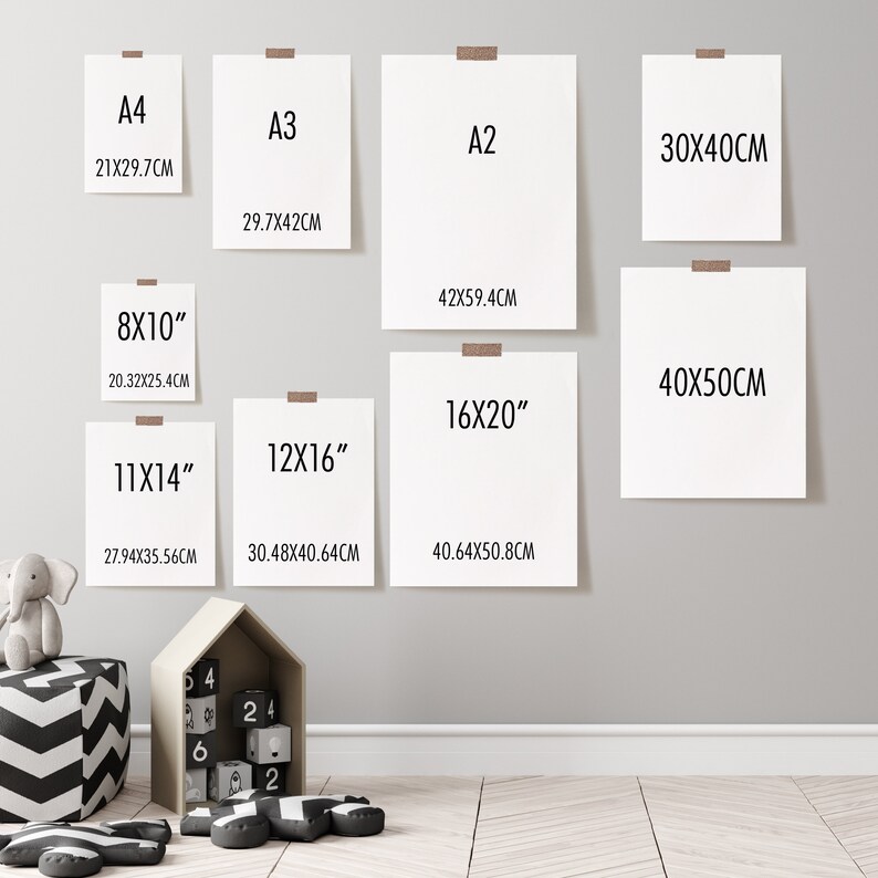 May include: A white wall with eight different sized paper frames, each with a different measurement in inches and centimeters. The frames are hung on the wall in a staggered pattern. The frames are all white and have a simple, modern design.