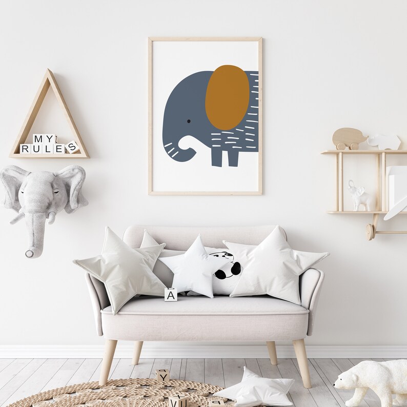 May include: A light gray couch with two white pillows and a white star-shaped pillow with a black panda bear design. A framed print of a blue and brown elephant is hanging on the wall above the couch. The couch is in a room with a wooden shelf and a wooden triangle shelf with the words "MY RULES" on it.