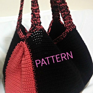 May include: A black and coral crocheted tote bag with a contrasting color pattern. The bag has two long straps and the word "PATTERN" is written in pink on the front.