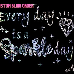 May include: A sparkly rhinestone design that reads "Every day is a sparkle day" with a diamond and stars. The design is on a black background and includes the text "Custom Bling Order" and "by @blingdots".