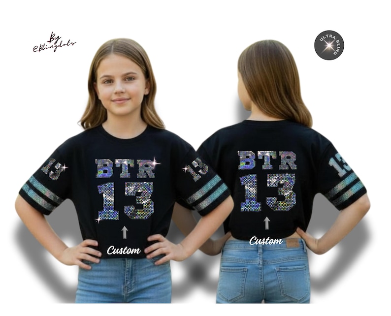 May include: Black cropped t-shirt with the text "BTR 13" in sparkling, iridescent rhinestones. The sleeves have silver and blue stripes and the number "13". The word "Custom" is below the number 13.