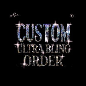 May include: The text CUSTOM ULTRA BLING ORDER is displayed in a bold, sans-serif font against a solid black background. Each letter is composed of numerous small, reflective, multi-colored rhinestones that create a sparkling, starburst effect.