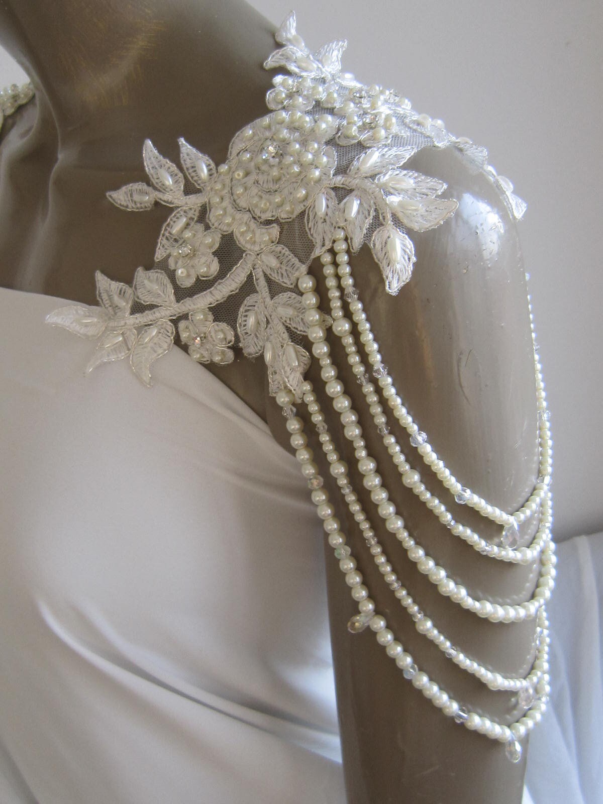 Detachable straps. Beads and pearls dotted throughout on tulle