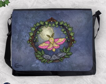 May include: A black messenger bag featuring a graphic print of a yellow and pink moth centered within a circular frame of green leaves and tree branches against a dark blue background with a full moon, stars, and gray stones at the base.