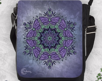 May include: A black messenger bag with a purple flap featuring a symmetrical mandala design composed of purple butterfly wings and green leaf accents. The text Sylluna is printed in the bottom left corner of the flap in a white font.