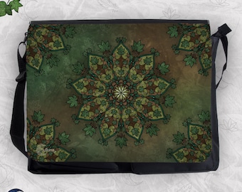 May include: A black messenger bag featuring a central mandala design composed of green and brown maple leaves. The background displays a gradient of earthy green and brown tones with additional leaf patterns. The brand name Sylluna is visible.