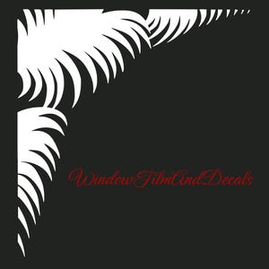 May include: A white corner decal featuring a stylized palm leaf pattern on a black background. The text WindowFilmAndDecals is printed in a red cursive font in the lower right section of the image, positioned below the white leaf design.
