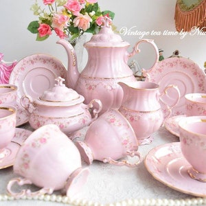 Pink porcelain coffee set with floral and gold decorations