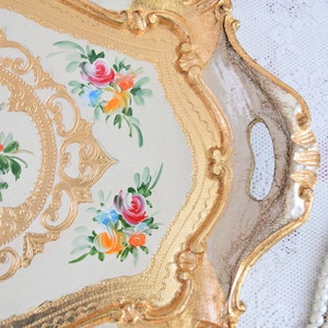 May include: A white and gold serving tray with a floral design. The tray has a decorative border and two handles.
