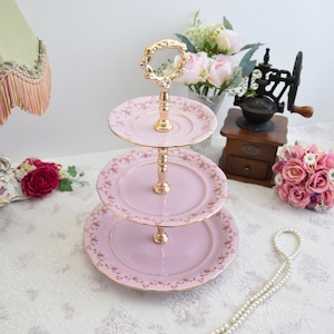 Pink porcelain cake stander with floral decorations by LL