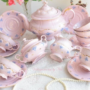 Collectibles pink porcelain coffee set with floral and gold decorations