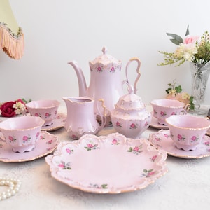 Pink porcelain coffee set with floral and gold decorations