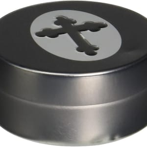 May include: A round, silver metal container with a black cross design on the lid. The cross is inside a circle with a white background.
