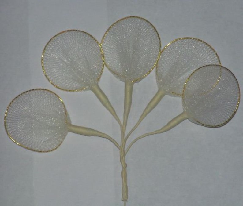 May include: Five white tulle flower accents with gold wire rims. The tulle is gathered at the centre of each accent and attached to a white stem.