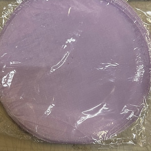 May include: A package of lavender-colored tulle circles, perfect for crafting or decorating.