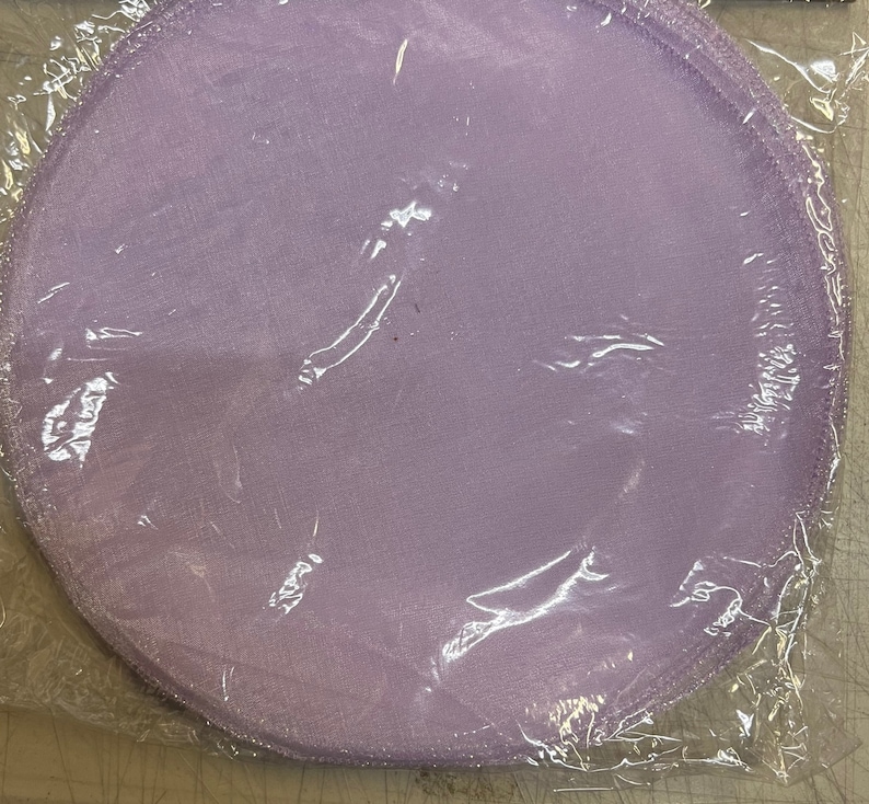 May include: A package of lavender-colored tulle circles, perfect for crafting or decorating.