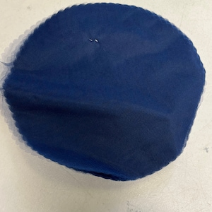 May include: A round, navy blue tulle fabric circle.