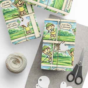 May include: Gift wrap featuring a comic strip design with a cartoon golfer in a green hat and yellow shirt. The text bubbles say "Just like I planned" and "Par? Let's stay realistic." The gifts are tied with twine and have white tags. Scissors and twine are also visible.
