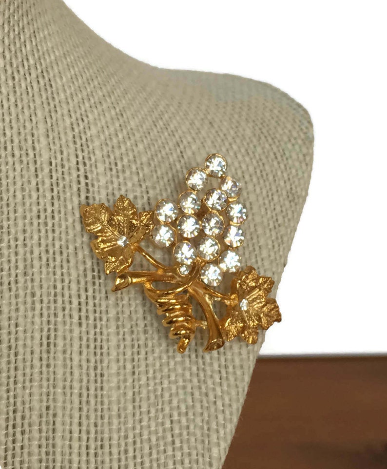 Grape and leaf cluster brooch vintage gold tone pin clear rhinestones