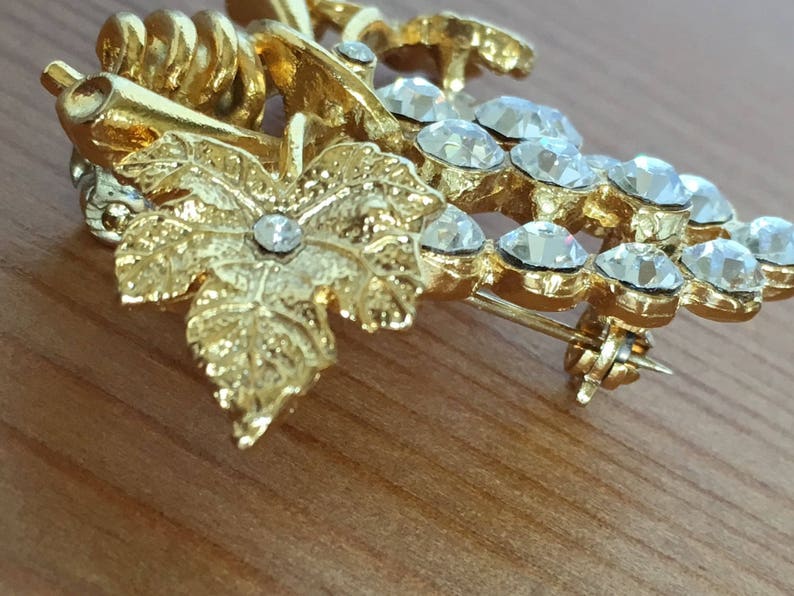 Grape and leaf cluster brooch vintage gold tone pin clear rhinestones