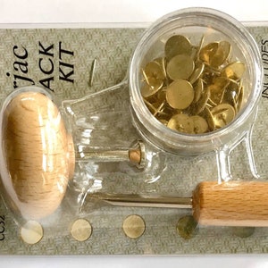 May include: A set of 60 steel tacks in a clear plastic container with a wooden magnetic pusher and extractor. The tacks are gold in color and the container is labeled "INCLUDES Magnetic Pusher Extractor Set of 60 Steel Tacks".