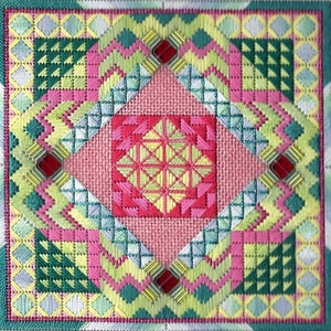 May include: A colourful needlepoint design with a central diamond shape surrounded by a geometric pattern. The design features shades of pink, green, yellow, and blue.