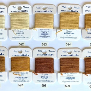 May include: Ten spools of embroidery floss in various shades of brown and beige. Each spool is labeled with the brand name "Tilli Tomas essentials", the color name, and the color number. The spools are arranged in two rows of five.