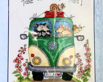May include: Cross stitch kit featuring a green and white Volkswagen van with the text "Take the slow road!" and "Relax" on the back. The van is filled with animals, including a cat, two mice, and a snail. The kit includes 14 count white Zweigart Aida fabric, pre-sorted stranded cottons, a needle, stitch diagram, and instructions. Finished size is 8.7 inches by 9.4 inches.