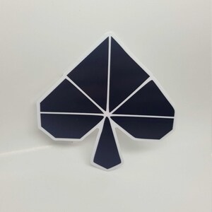 May include: A black and white sticker of a stylized spade shape.