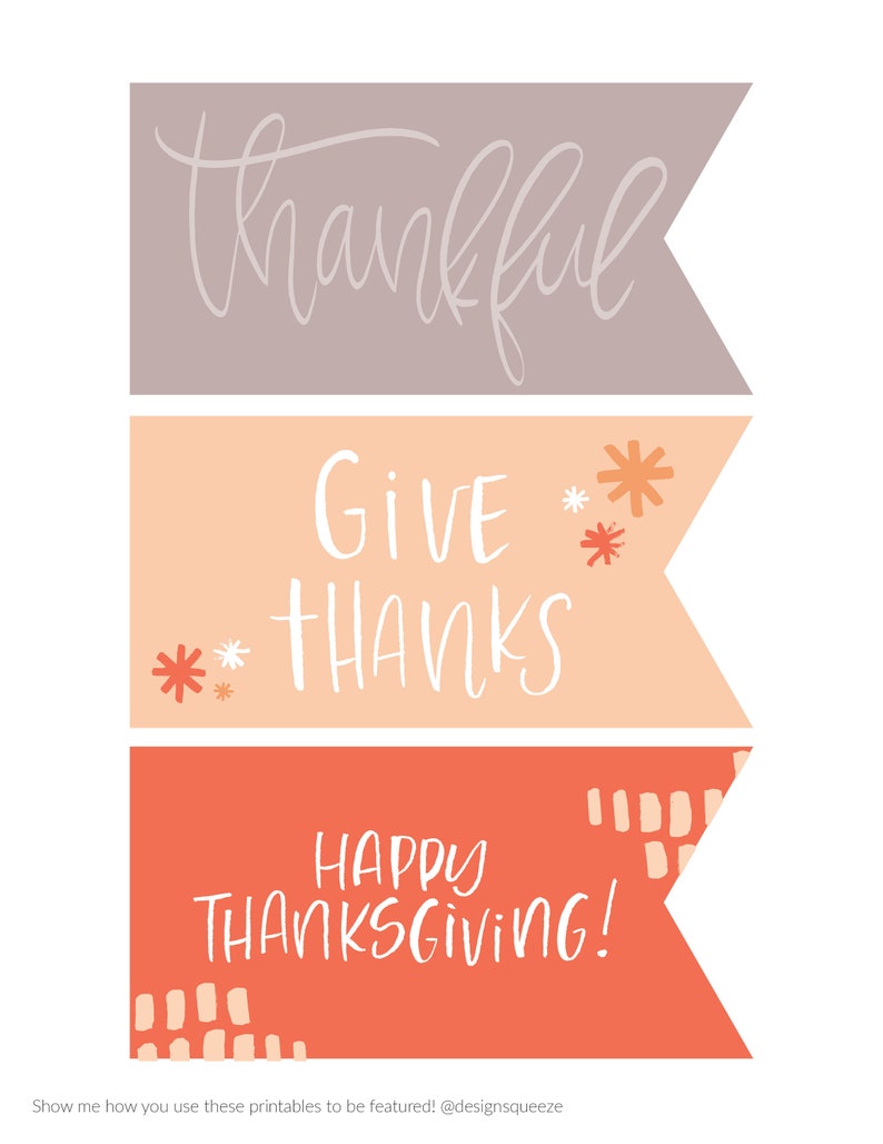 May include: Three colorful banner-shaped designs with Thanksgiving-themed text. The top banner is taupe with the word "thankful". The middle banner is peach with "GIVE THANKS". The bottom banner is orange with "HAPPY THANKSGIVING!"