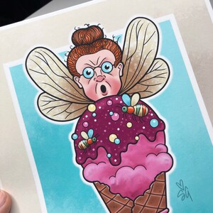 May include: A cartoon illustration of a fairy with red hair and glasses, wearing a pink and purple ice cream cone with sprinkles and bees. The fairy is wearing a pair of wings and has a surprised expression on her face.