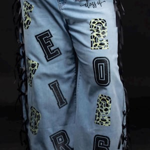 cheetah print and black glitter numbers and letters spelling out " SENIOR Class of 2026”
