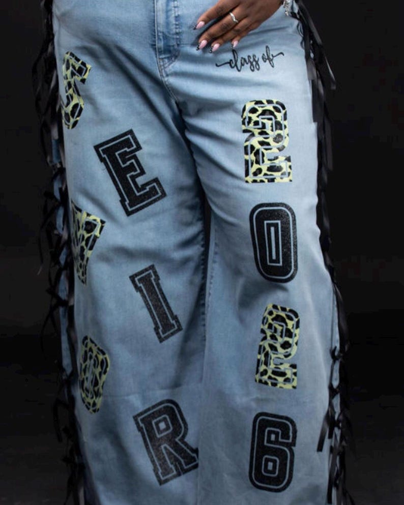 cheetah print and black glitter numbers and letters spelling out " SENIOR Class of 2026”
