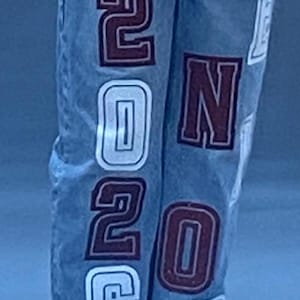 white and maroon lettering and patches. The text "McKinley class of" is  on the front pocket. The numbers "2026" are prominently displayed on the legs. SENIOR