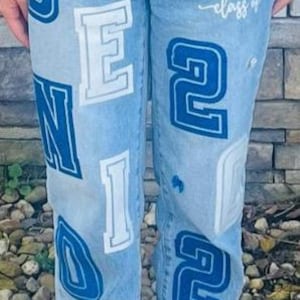 Blue glitter and white glitter with the words "SENIOR" and "2026", along with the text "Chrystian SHS class of".