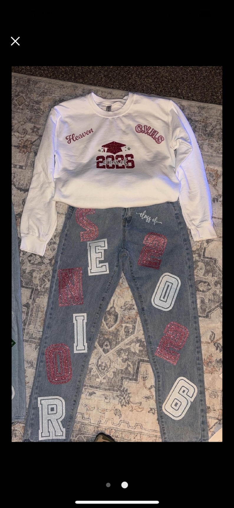May include: A white sweatshirt and denim jeans set. The sweatshirt has the word "Heaven" and "CVHS" printed on it, along with a graduation cap and the year "2026". The jeans have the word "SENIOR" and the number "26" on them.