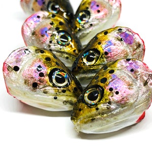 May include: Five realistic trout fish head lures with iridescent scales and black spots. The lures are painted with a realistic finish and have black eyes with iridescent pupils.