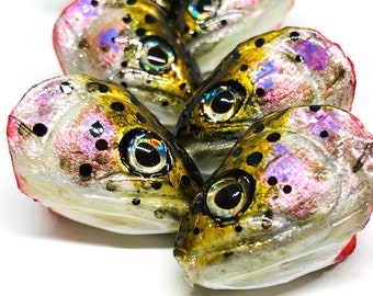 May include: Five realistic trout fish head lures with iridescent scales and black spots. The lures are painted with a realistic finish and have black eyes with iridescent pupils.