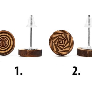 May include: Two pairs of wooden earrings with silver posts. The first pair features a circular design with concentric circles. The second pair features a spiral design with a square in the center.