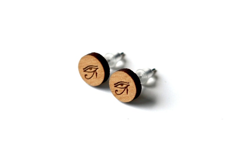 Customizable round stud earrings. Laser-cut engraved varnished wood, Egyptian eye Horus glyph jewel. Visual god pyramid egypt image 1