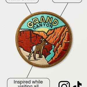 May include: Embroidered patch featuring a Grand Canyon landscape with a bighorn sheep. The patch is hand-drawn and reads "Grand Canyon" in yellow lettering. The design includes red, orange, and turquoise colors. The text "Inspired while visiting all 63 National Parks" is also included.