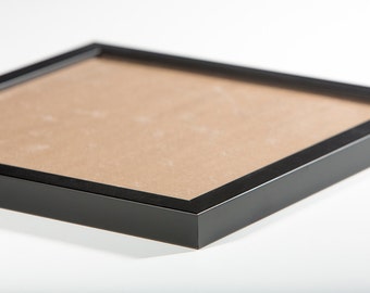 May include: A black picture frame with a brown mat. The frame is made of wood and has a simple, modern design.