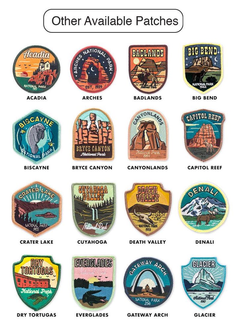 May include: A collection of embroidered patches featuring various U.S. National Parks. Each patch showcases a unique design and the park's name, including Acadia, Arches, Badlands, Big Bend, and others. The patches are colorful and detailed.