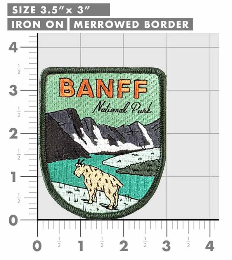 May include: A rectangular iron-on patch with a merrowed border, measuring 3.5" x 3". The patch features the text "BANFF National Park" above a mountain and lake scene with a goat. The patch has a green, black, and tan color scheme.